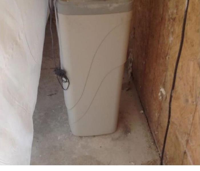 water filter in an empty room with wood walls exposed