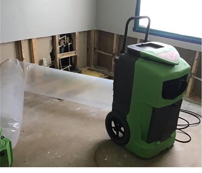 green machine in the middle of a empty room