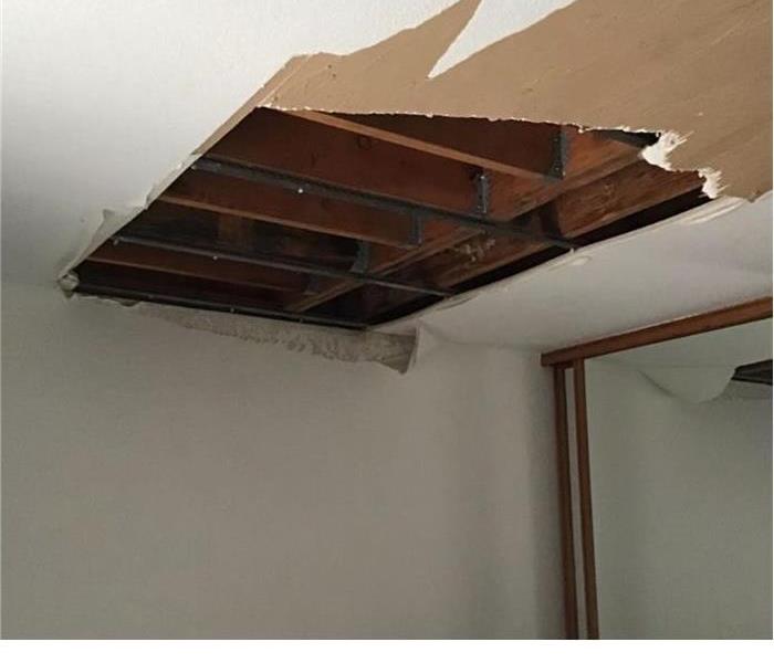 exposed ceiling with half of the drywall falling